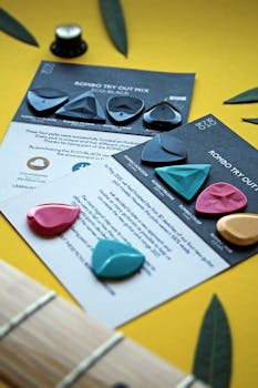 Set of vibrant Rombo guitar picks arranged artistically on product cards.